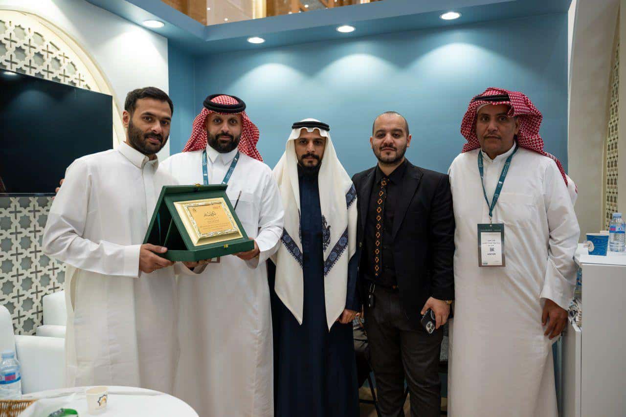 Bawabet Al-Miqat team receiving recognition at an Umrah industry ceremony